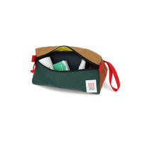 General shot of travel toiletries inside Topo Designs Dopp Kit bag in 100% recycled nylon Forest green & Khaki brown.