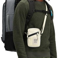 Model wearing Topo Designs Men's Global pullover Sweater recycled washable Italian wool in "Olive" green.