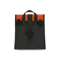 General shot of velcro bike attachment points on back of Topo Designs Cooler Bag insulated lunch box in forest green and clay orange recycled nylon.