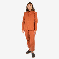 Front model shot of Topo Designs Women's Dirt Shirt & Pants in "Brick" orange.