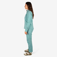 Side model shot of Topo Designs Women's Dirt Shirt & Pants in "Sage" green.